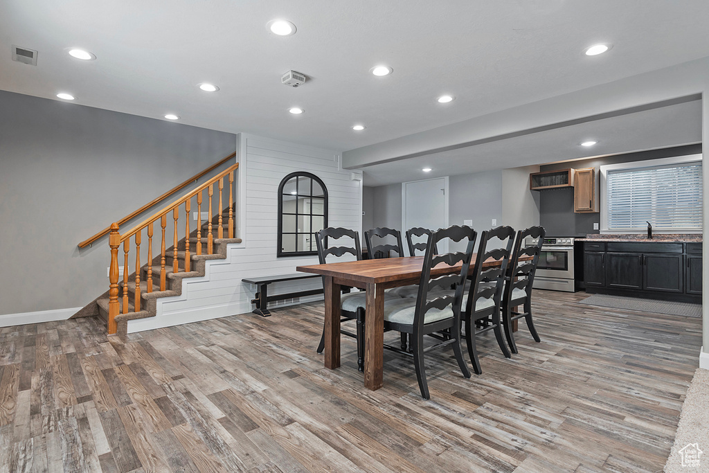 Dining room with light wood-type flooring and sink