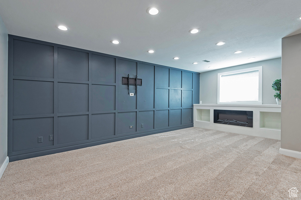 Unfurnished living room featuring light colored carpet