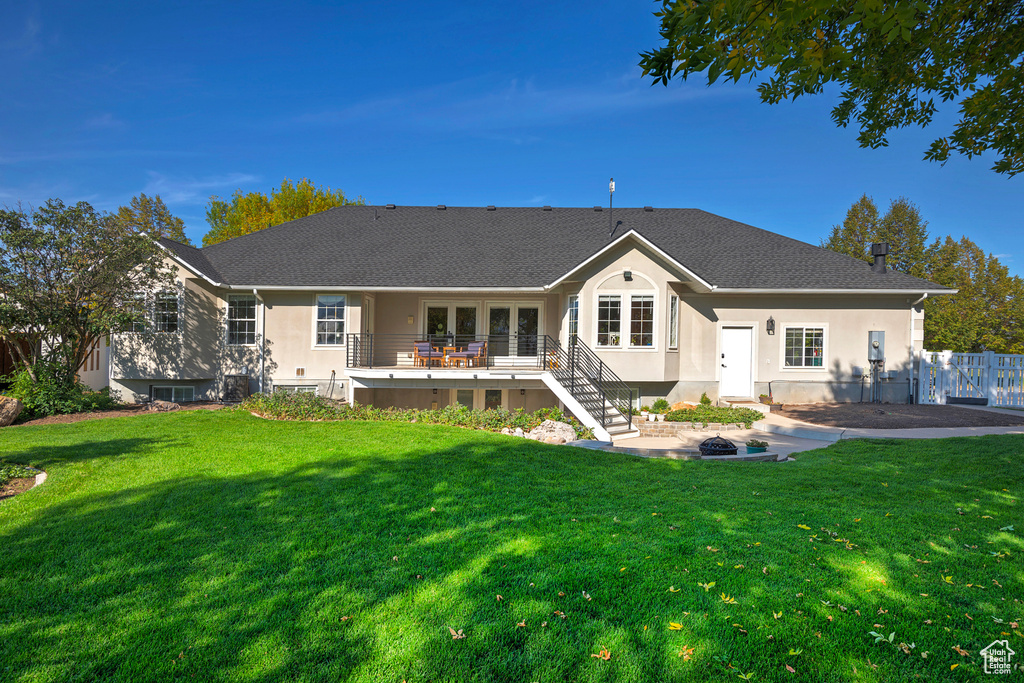 Back of house with a yard