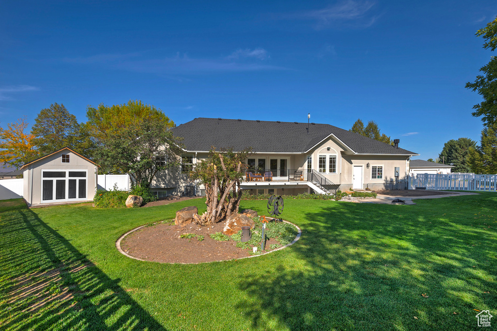 Back of house with a yard