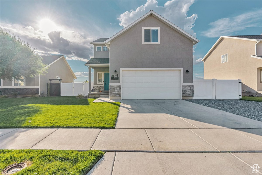 View of front property with a front lawn and a garage