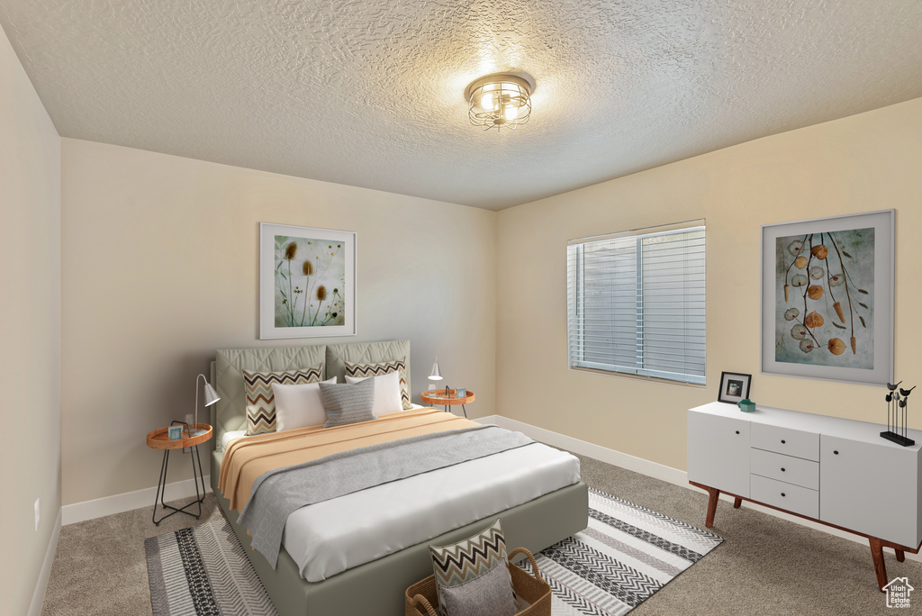 Carpeted bedroom featuring a textured ceiling