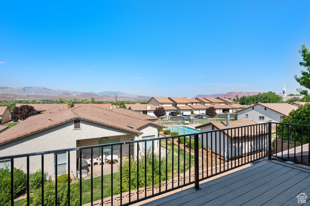 Wooden deck featuring a fenced in pool and a mountain view