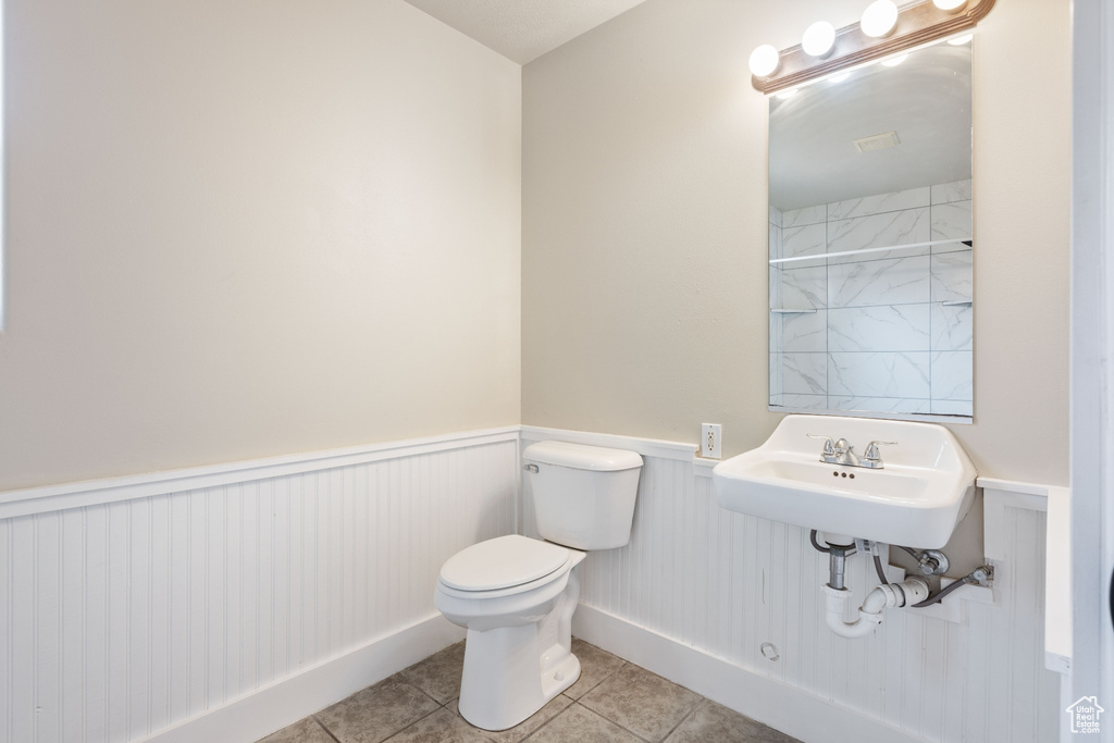 Bathroom with sink, tile patterned flooring, and toilet