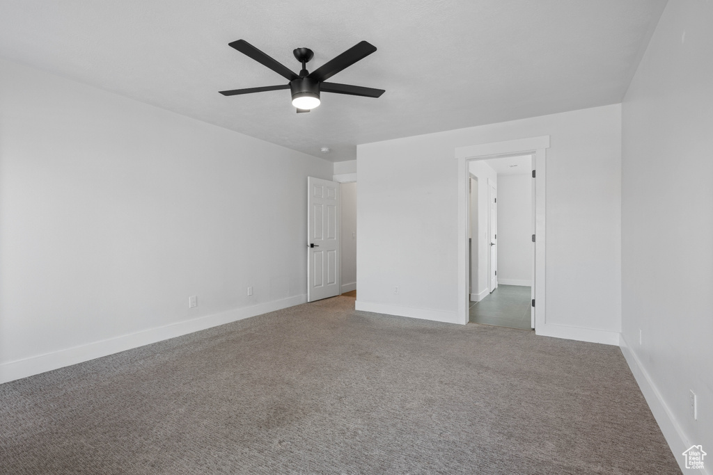 Unfurnished bedroom with ceiling fan and carpet floors