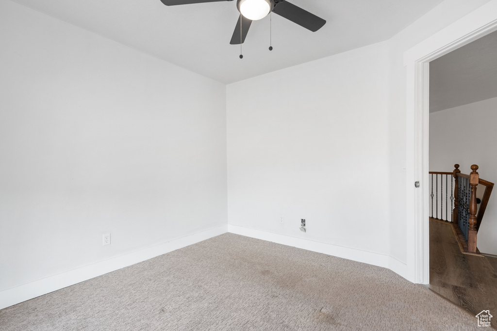 Unfurnished room with ceiling fan and carpet