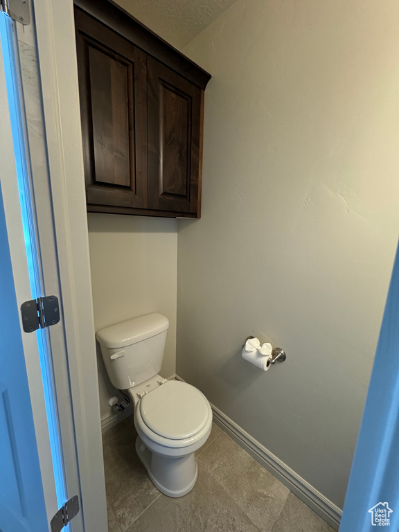 Bathroom featuring tile patterned flooring and toilet