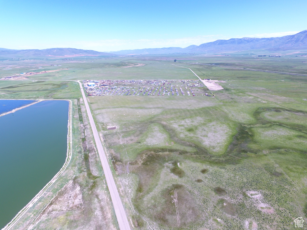 Drone / aerial view with a water and mountain view