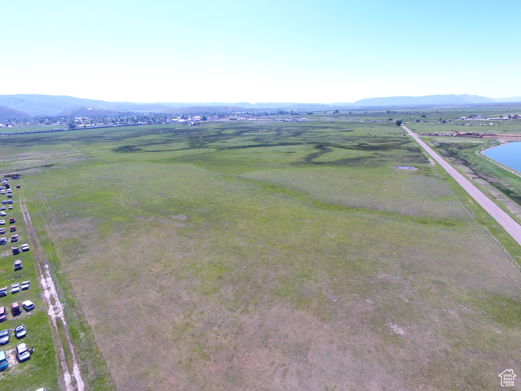 Drone / aerial view featuring a rural view and a water and mountain view