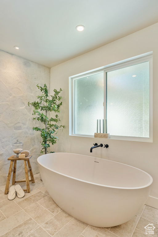 Bathroom featuring a bath and a healthy amount of sunlight