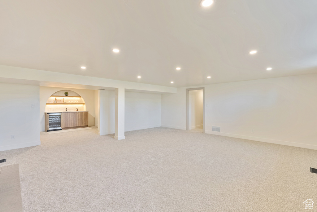 Basement featuring light carpet