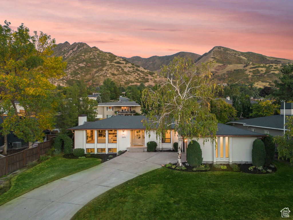 View of front facade with a lawn and a mountain view