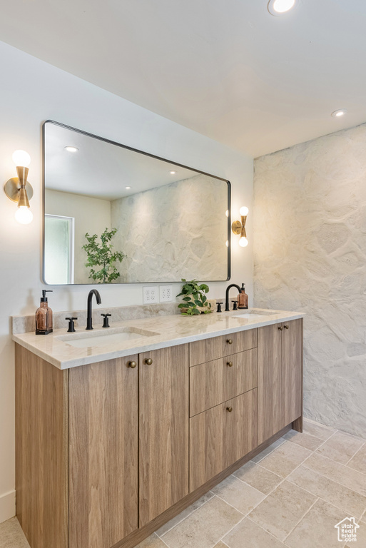 Bathroom featuring vanity, tile walls, and tile patterned flooring