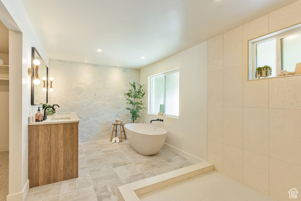 Bathroom with a tub to relax in and vanity