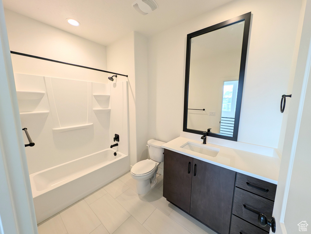 Full bathroom featuring vanity, bathtub / shower combination, toilet, and tile patterned flooring