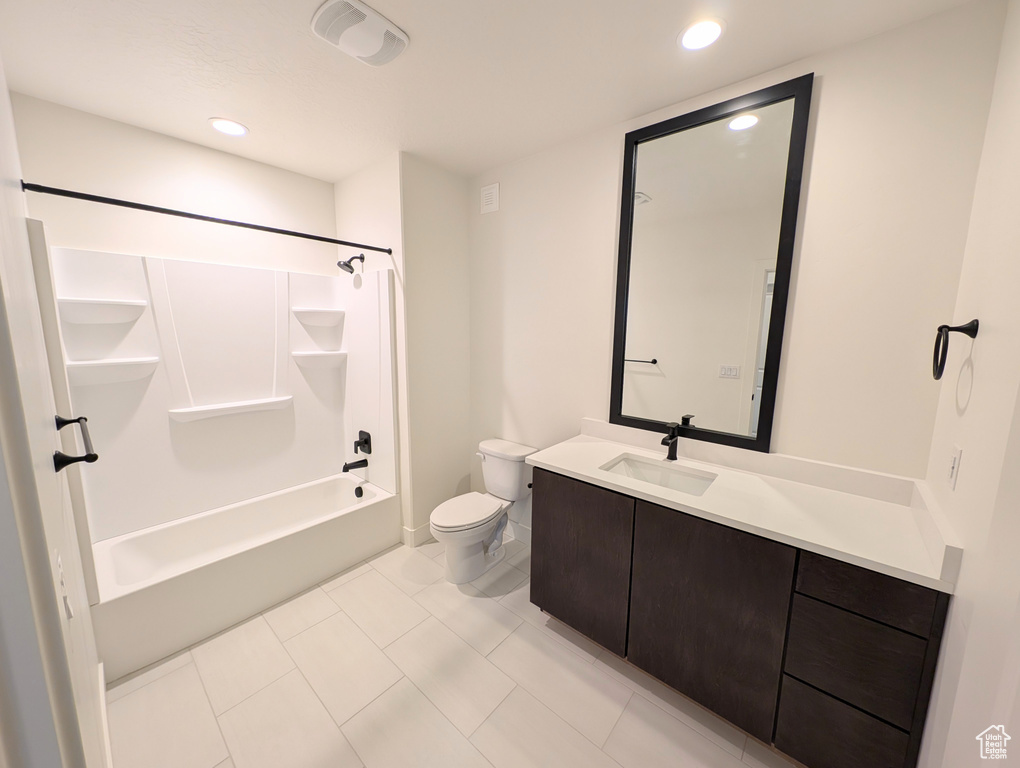 Full bathroom with tile patterned floors, vanity, toilet, and shower / washtub combination