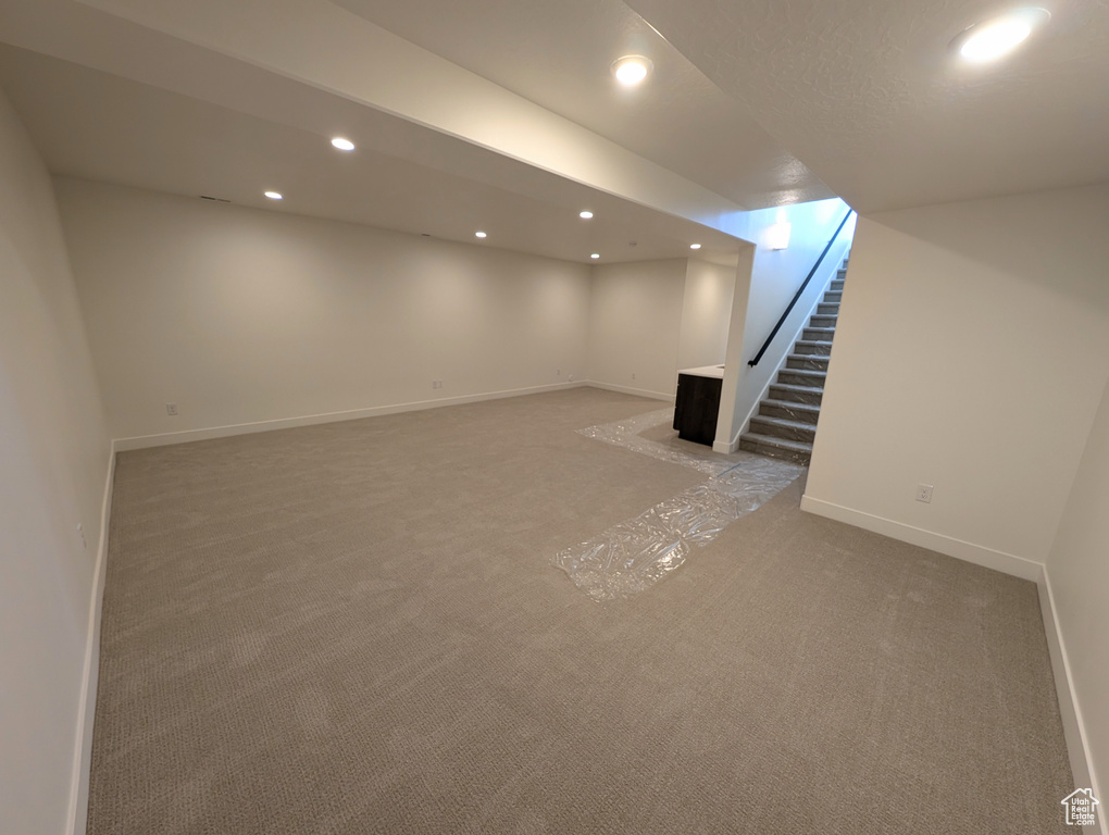 Basement with light carpet