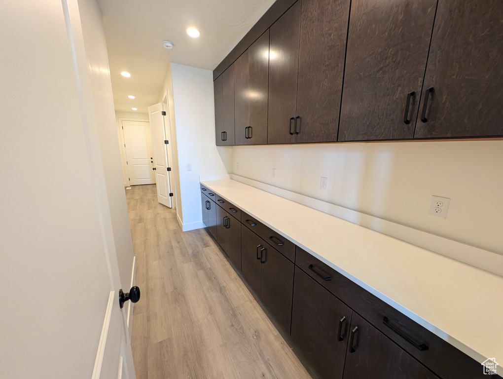 Interior space with dark brown cabinetry and light wood-type flooring