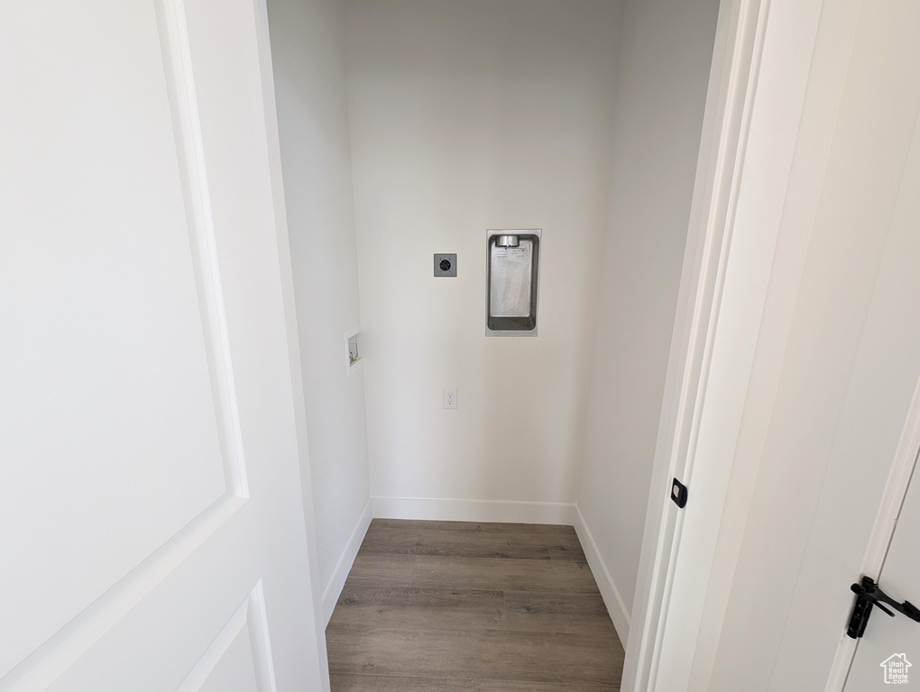 Interior space with hookup for an electric dryer and light wood-type flooring