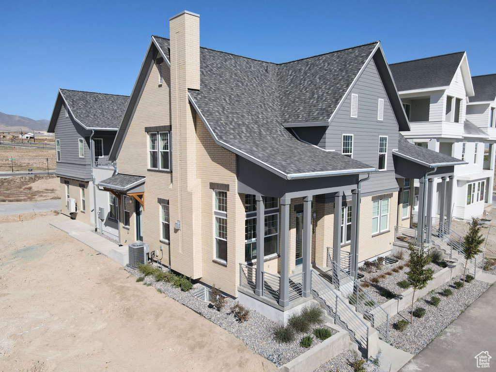 View of side of home featuring central AC