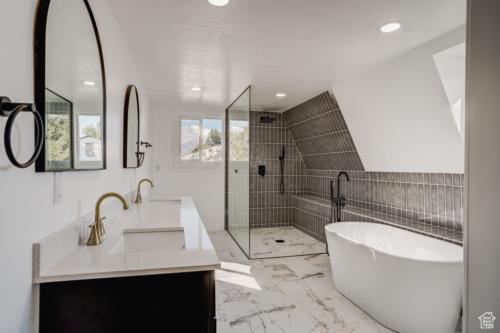 Bathroom featuring independent shower and bath and vanity