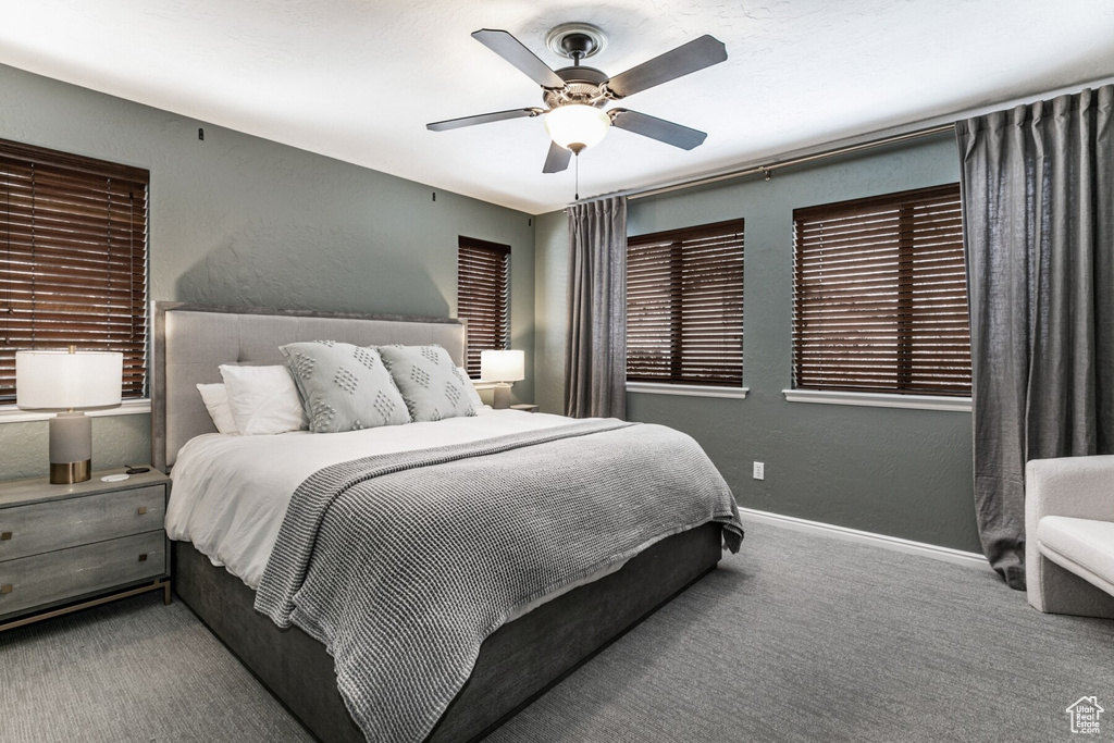 Carpeted bedroom with ceiling fan