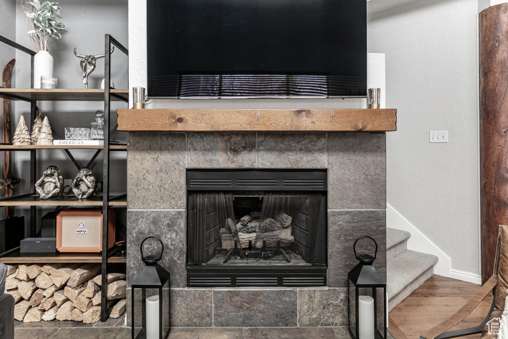 Details featuring hardwood / wood-style flooring and a tile fireplace