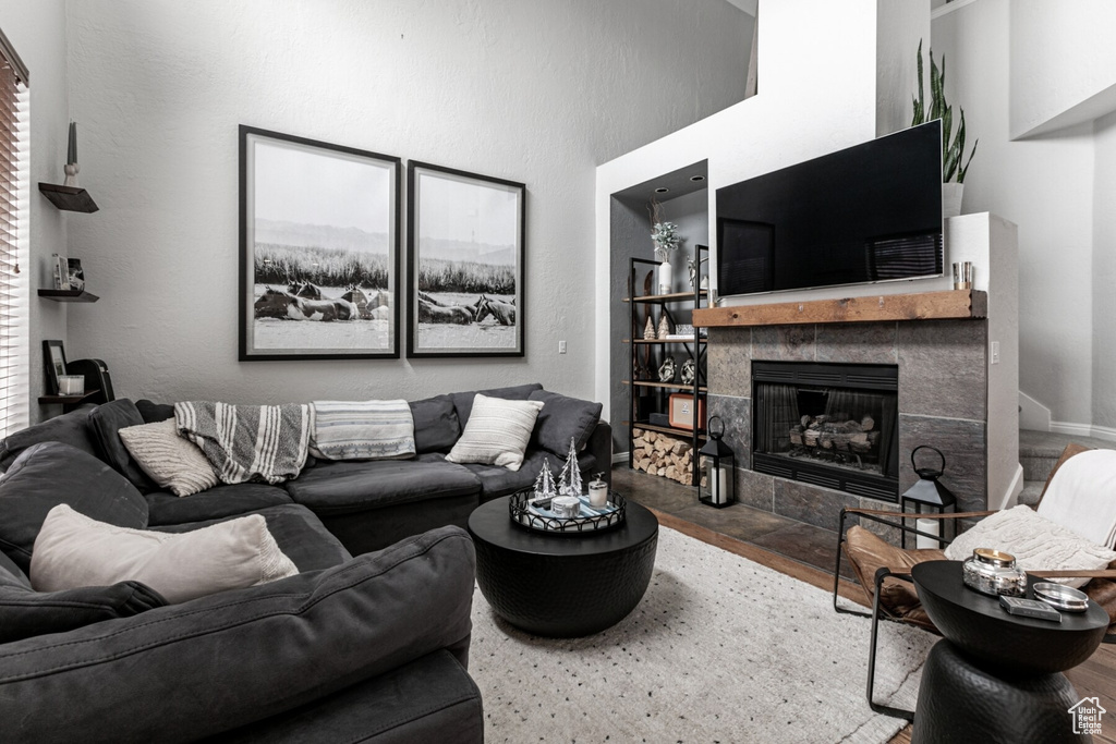 Living room featuring hardwood / wood-style floors and a tile fireplace