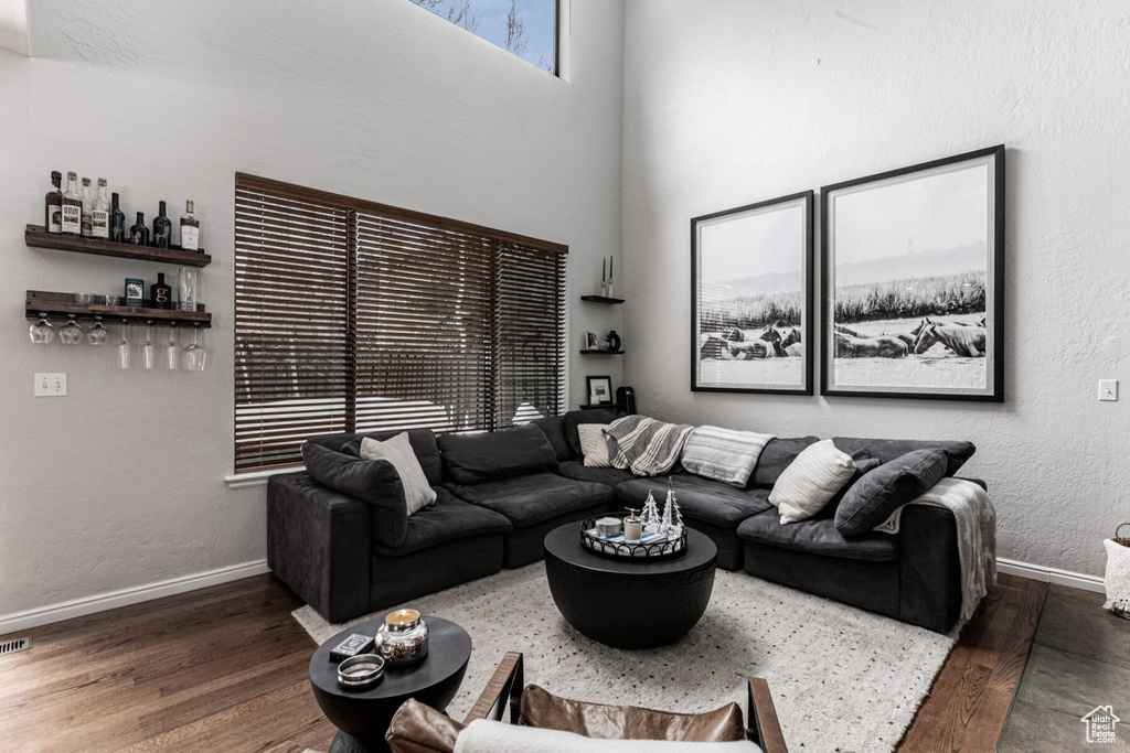 Living room featuring dark wood-type flooring and bar area