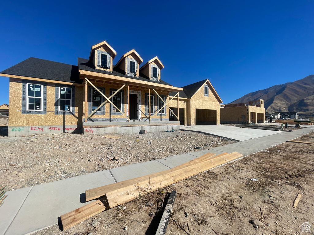 View of front of house with a mountain view and a porch