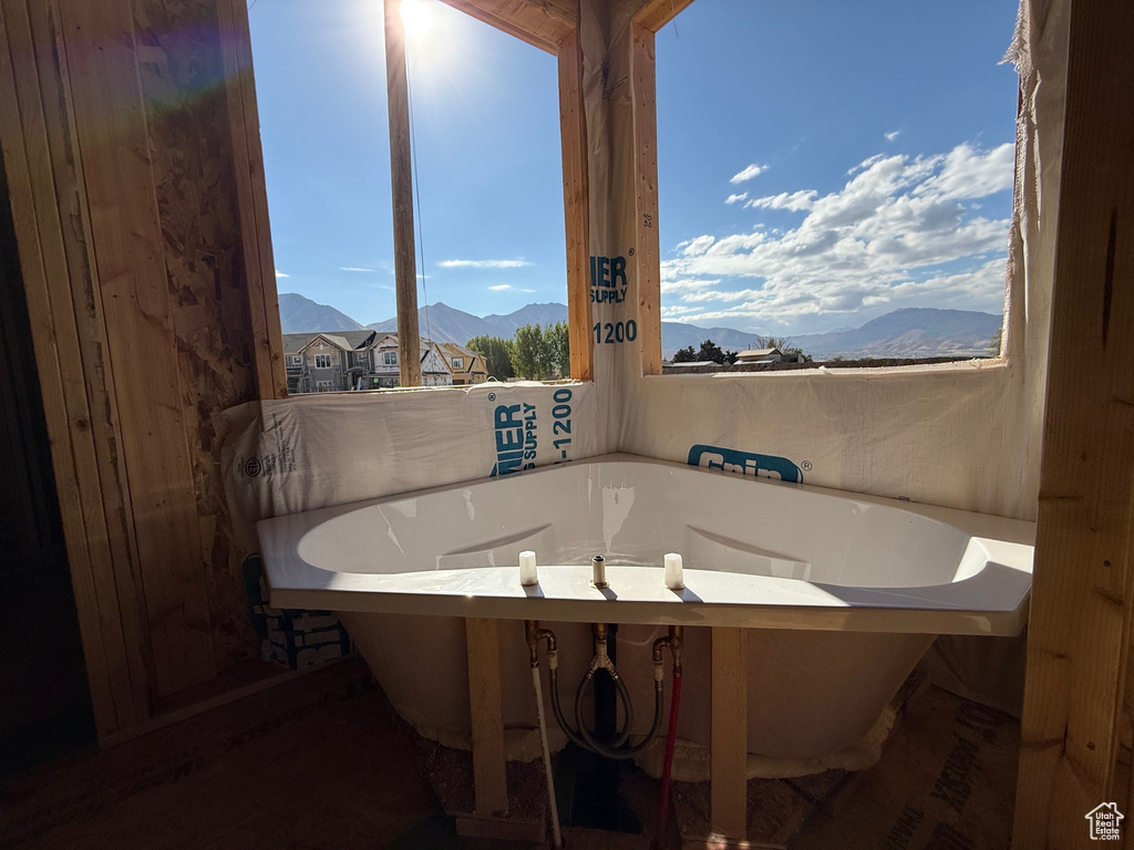 Bathroom featuring a mountain view, wood walls, and a washtub