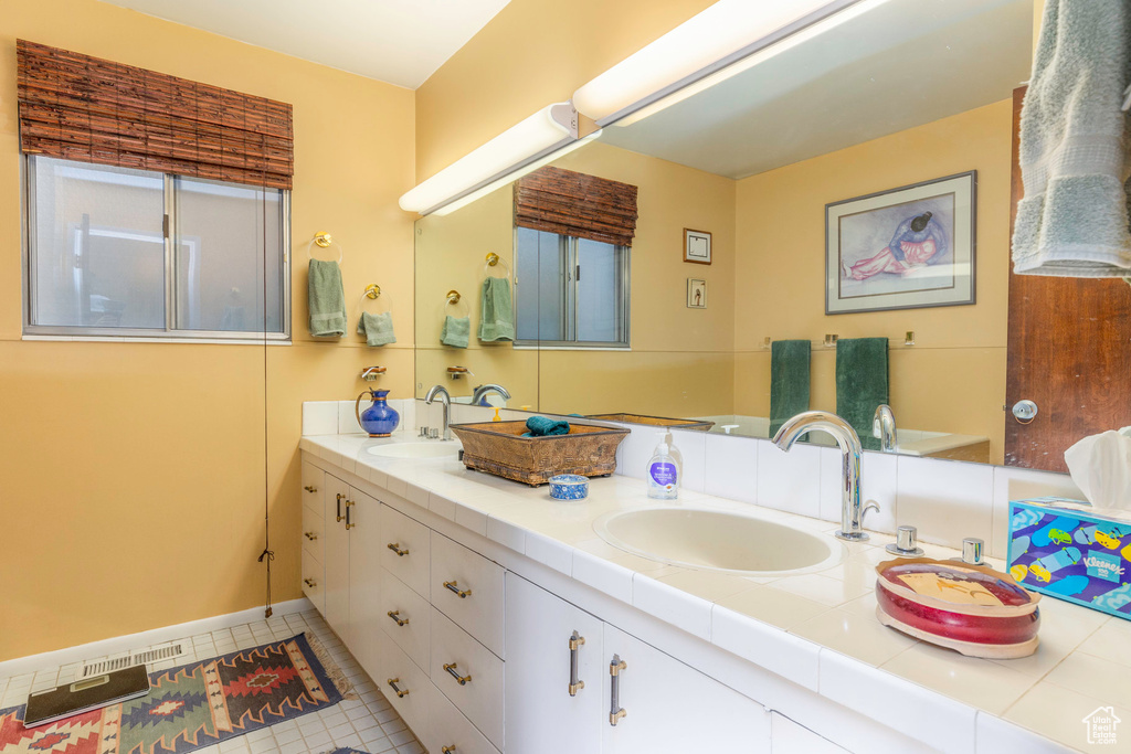 Bathroom featuring tile patterned floors and vanity