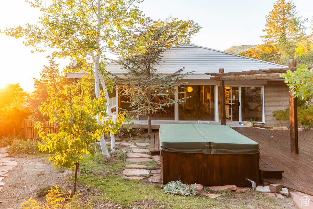 Exterior space with a pergola and a hot tub