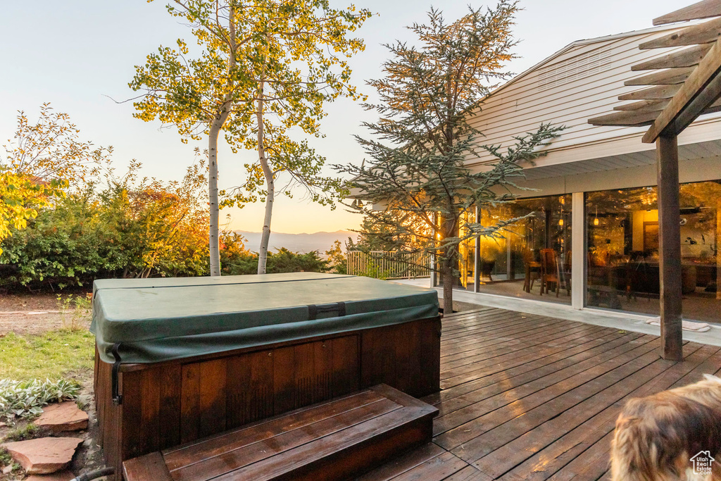 Deck at dusk with a hot tub