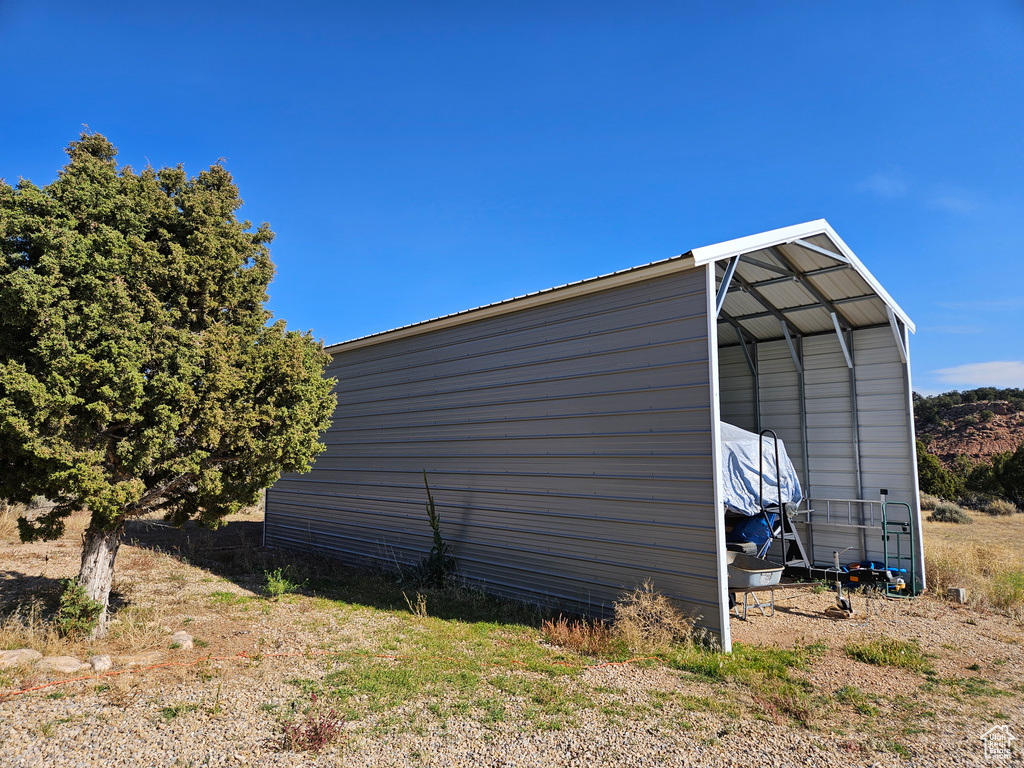 View of outbuilding featuring a carport