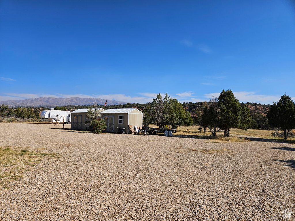 View of yard with a rural view and a mountain view