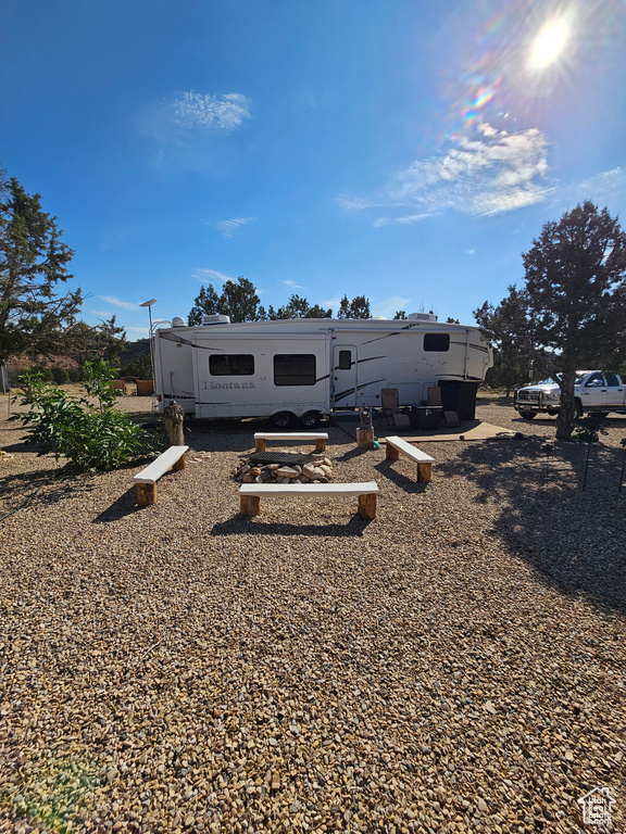 Back of property featuring a fire pit