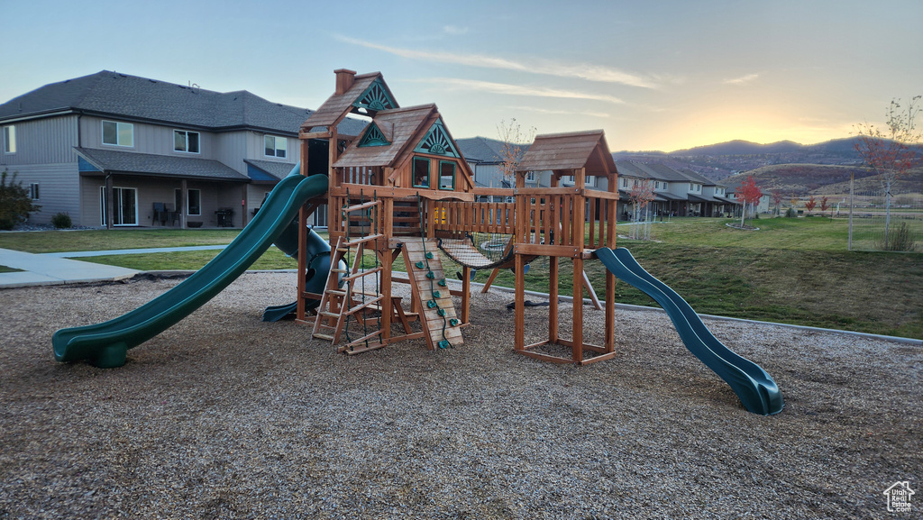 Playground at dusk with a yard