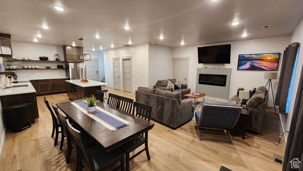 Dining area featuring sink and light wood-type flooring