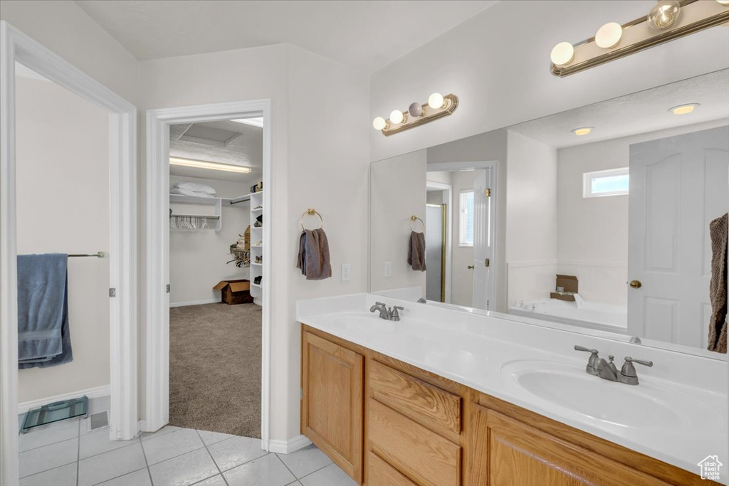 Bathroom featuring tile patterned flooring and vanity