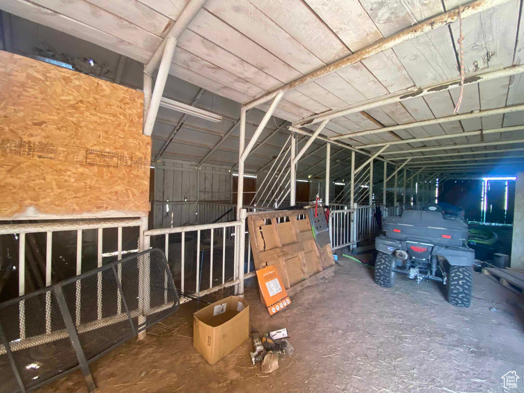 Misc room featuring lofted ceiling and concrete flooring