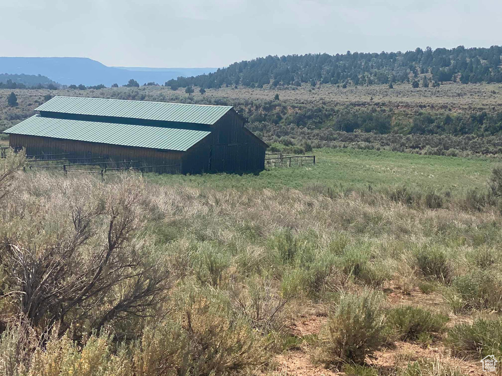 View of outdoor structure with a rural view and a mountain view