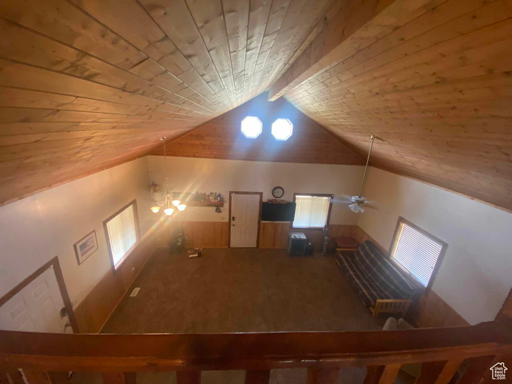 Bonus room featuring wooden ceiling, lofted ceiling with beams, and ceiling fan