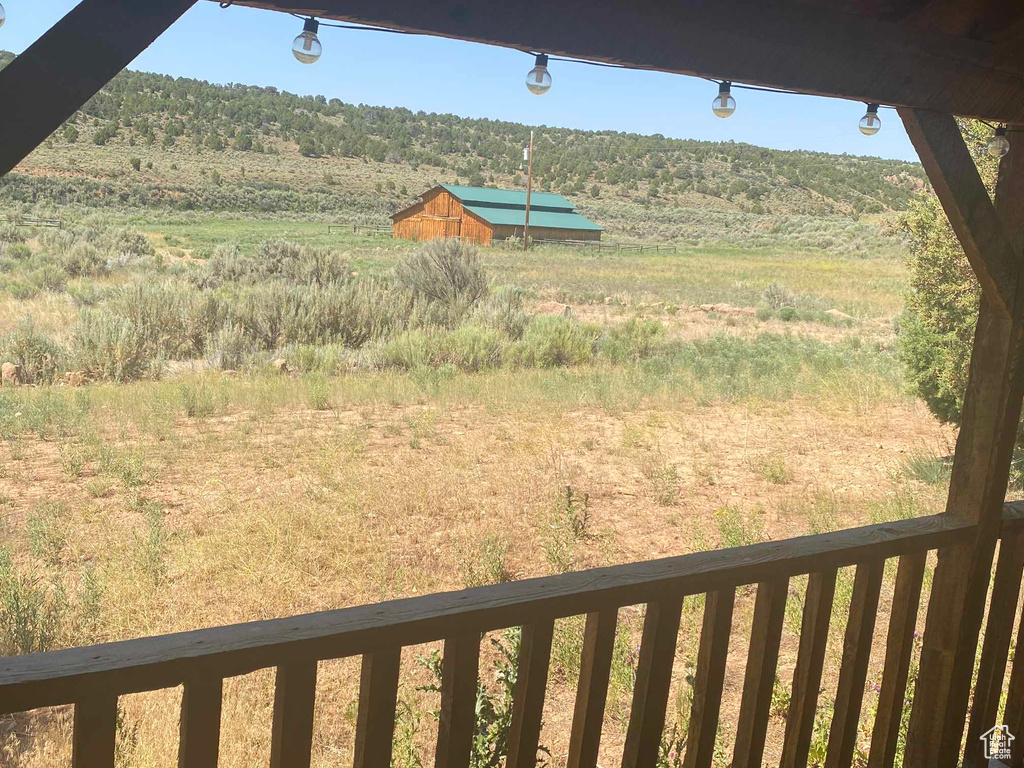 View of yard featuring a balcony and a rural view