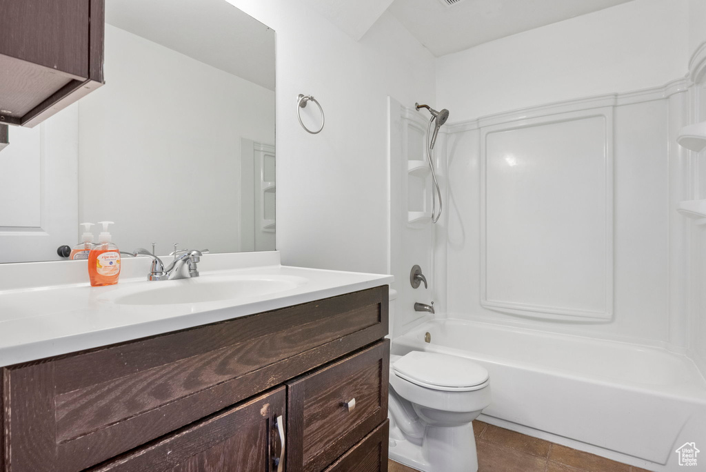 Full bathroom featuring bathtub / shower combination, tile patterned floors, vanity, and toilet