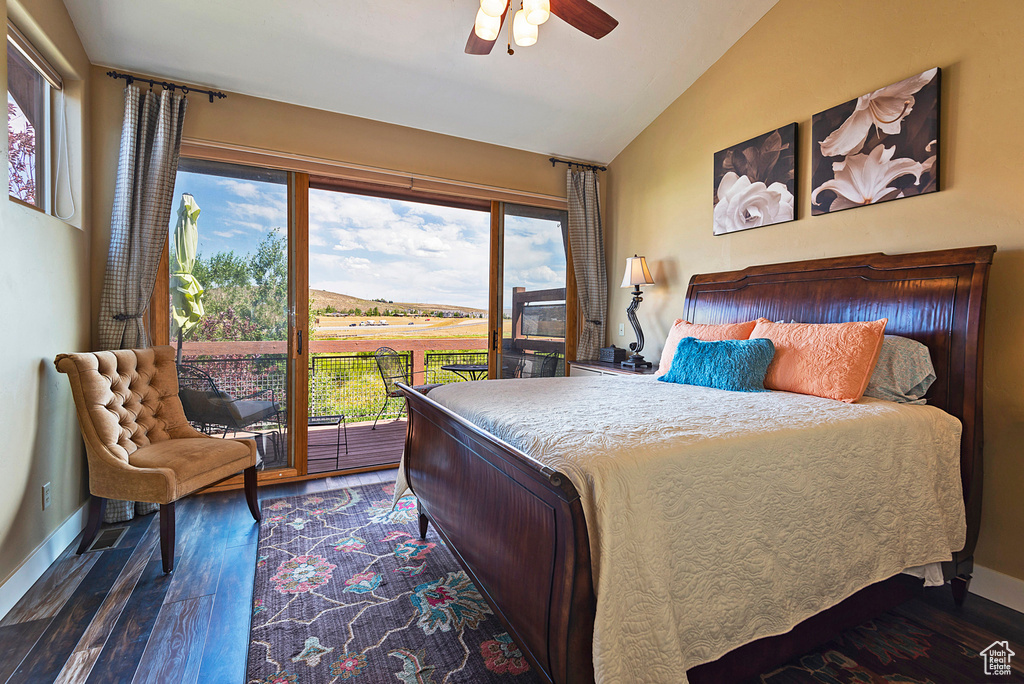 Bedroom featuring access to exterior, ceiling fan, vaulted ceiling, and dark hardwood / wood-style flooring