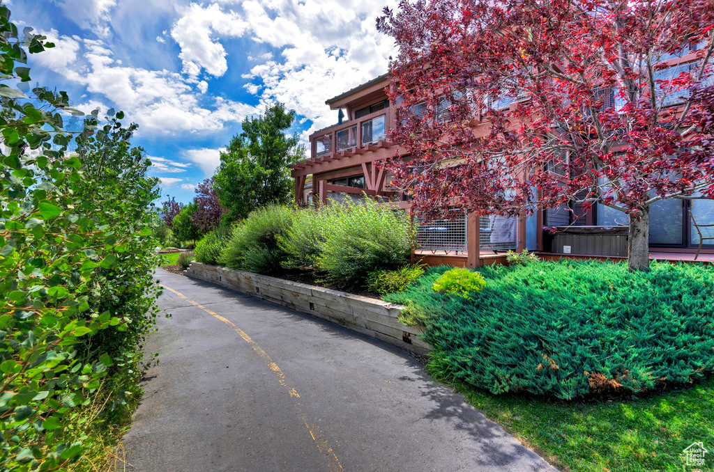 View of side of home featuring a wooden deck