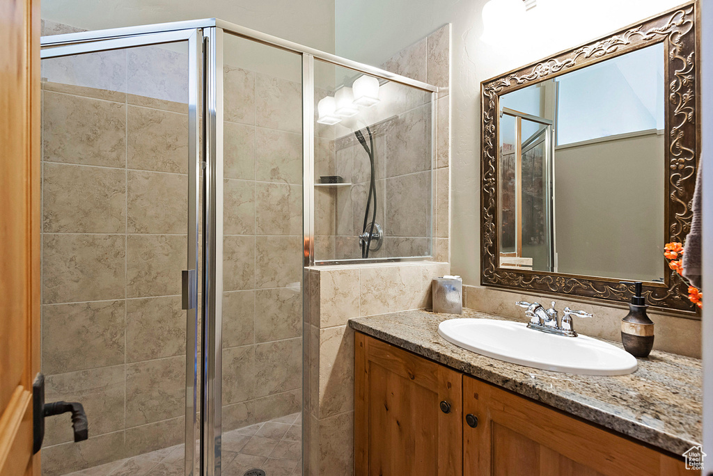 Bathroom featuring walk in shower and vanity