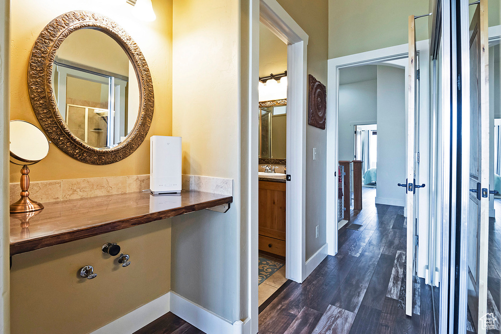 Hallway with dark hardwood / wood-style flooring and sink