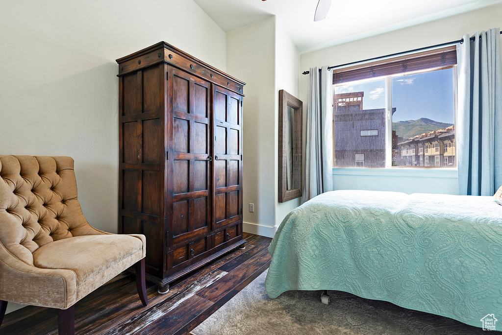 Bedroom featuring a mountain view, ceiling fan, and dark hardwood / wood-style floors